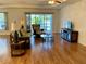 Bright living room with hardwood floors, sliding glass doors, and ample natural light at 2057 Wonderwin St, Port Charlotte, FL 33948