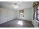 Well-lit bedroom featuring carpet and a ceiling fan at 21241 Winside Ave, Port Charlotte, FL 33952