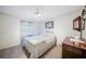 Bedroom with carpeted floor, ceiling fan, and wood dresser at 21241 Winside Ave, Port Charlotte, FL 33952