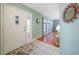 Bright and airy entryway with hardwood floors and a view of the living room at 21241 Winside Ave, Port Charlotte, FL 33952