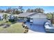 Single-story home with a landscaped yard, driveway, and attached garage at 21241 Winside Ave, Port Charlotte, FL 33952