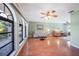 Living room with hardwood floors, arched windows, and a ceiling fan at 21241 Winside Ave, Port Charlotte, FL 33952