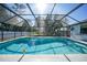 Inviting refreshing blue pool, surrounded by a screened enclosure at 21241 Winside Ave, Port Charlotte, FL 33952