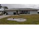 One-story home with attached garage, and landscaped lawn at 2171 Bayou Rd, Punta Gorda, FL 33950