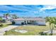 Low-set ranch home with tidy lawn and palm trees at 2171 Bayou Rd, Punta Gorda, FL 33950