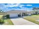 One-story house featuring a white exterior and a two-car garage at 2171 Bayou Rd, Punta Gorda, FL 33950