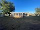 Back exterior view of the house with a sunroom and yard at 21921 Beverly Ave, Port Charlotte, FL 33952