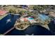 Aerial view showing community pool, tennis courts, and lake at 23465 Harborview Rd # 1006, Punta Gorda, FL 33980