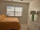 Bedroom with double bed, lamp, and white dresser at 23465 Harborview Rd # 1006, Punta Gorda, FL 33980