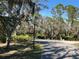 Tree-lined community road with lush landscaping at 23465 Harborview Rd # 1006, Punta Gorda, FL 33980