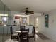 Dining area with glass top table and kitchen view at 23465 Harborview Rd # 1006, Punta Gorda, FL 33980