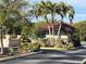 Community entrance with guardhouse and tropical landscaping at 23465 Harborview Rd # 1006, Punta Gorda, FL 33980