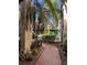 Brick walkway with tropical landscaping, leading to condo entrance at 23465 Harborview Rd # 1006, Punta Gorda, FL 33980