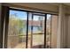 Sliding glass doors offer scenic view of lake and palm trees at 23465 Harborview Rd # 1006, Punta Gorda, FL 33980