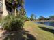 Landscaped waterfront view with a walking path at 23465 Harborview Rd # 1006, Punta Gorda, FL 33980