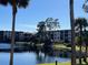 Community waterfront view with bridge and palm trees at 23465 Harborview Rd # 1006, Punta Gorda, FL 33980