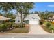 House with a white garage and green door, nicely landscaped yard at 238 Woodingham Trl, Venice, FL 34292