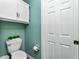 Clean bathroom with a toilet and wall-mounted storage at 238 Woodingham Trl, Venice, FL 34292