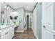 Modern bathroom with white cabinets and a barn door at 238 Woodingham Trl, Venice, FL 34292