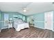 Spacious bedroom with light blue walls, wood flooring, and a ceiling fan at 238 Woodingham Trl, Venice, FL 34292