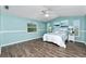 Serene bedroom with light blue walls and wood flooring at 238 Woodingham Trl, Venice, FL 34292