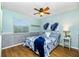 Cozy bedroom with light blue walls and a ceiling fan at 238 Woodingham Trl, Venice, FL 34292