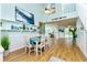 Bright dining room with a white table and hardwood floors at 238 Woodingham Trl, Venice, FL 34292