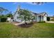 Gray house with green door, landscaped yard, and driveway at 238 Woodingham Trl, Venice, FL 34292