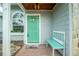 Charming teal front door with a welcoming bench at 238 Woodingham Trl, Venice, FL 34292