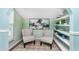 Cozy sitting area with two armchairs and built-in shelves at 238 Woodingham Trl, Venice, FL 34292