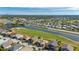 Aerial view of single-Gathering home with golf course and water views at 24060 Buckingham Way, Punta Gorda, FL 33980