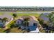 Tan house with driveway and palm trees near canal at 24060 Buckingham Way, Punta Gorda, FL 33980