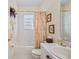 Well-lit bathroom, shower/tub combo, and floral accents at 24060 Buckingham Way, Punta Gorda, FL 33980