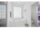 Bathroom with a large soaking tub and a glass block window at 24060 Buckingham Way, Punta Gorda, FL 33980