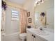 Clean bathroom with a shower/tub combo and updated vanity at 24060 Buckingham Way, Punta Gorda, FL 33980