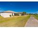 Houses line a walkway next to a golf course at 24060 Buckingham Way, Punta Gorda, FL 33980