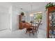 Bright dining area with wood table and chairs, offering a view to the outside at 24060 Buckingham Way, Punta Gorda, FL 33980