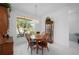 Bright dining area with wood table and chairs, offering a view to the outside at 24060 Buckingham Way, Punta Gorda, FL 33980