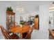 Bright dining area with wood table and chairs, view of living room at 24060 Buckingham Way, Punta Gorda, FL 33980