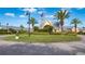 Community clubhouse with palm trees and landscaping at 24060 Buckingham Way, Punta Gorda, FL 33980