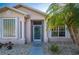 Front entrance with teal door, white columns, and screened porch at 24060 Buckingham Way, Punta Gorda, FL 33980