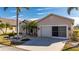 Tan house with double garage and palm trees at 24060 Buckingham Way, Punta Gorda, FL 33980