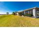 Tan house with lush landscaping and screened enclosure at 24060 Buckingham Way, Punta Gorda, FL 33980