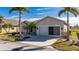 Tan house with double garage and palm trees at 24060 Buckingham Way, Punta Gorda, FL 33980