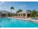 Community pool with shaded seating and hot tub at 24060 Buckingham Way, Punta Gorda, FL 33980