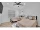 Bright bedroom with two twin beds, a dresser, and window blinds at 2418 Frantz St, North Port, FL 34286