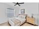 Bedroom with wood-look tile floor, ceiling fan, and neutral decor at 2418 Frantz St, North Port, FL 34286