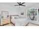 Spacious bedroom with a queen bed, dresser, and large window at 2418 Frantz St, North Port, FL 34286