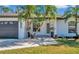 White house with dark gray accents, featuring a front door and landscaping at 2418 Frantz St, North Port, FL 34286