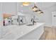 Modern kitchen island with white cabinets and quartz countertops at 2418 Frantz St, North Port, FL 34286